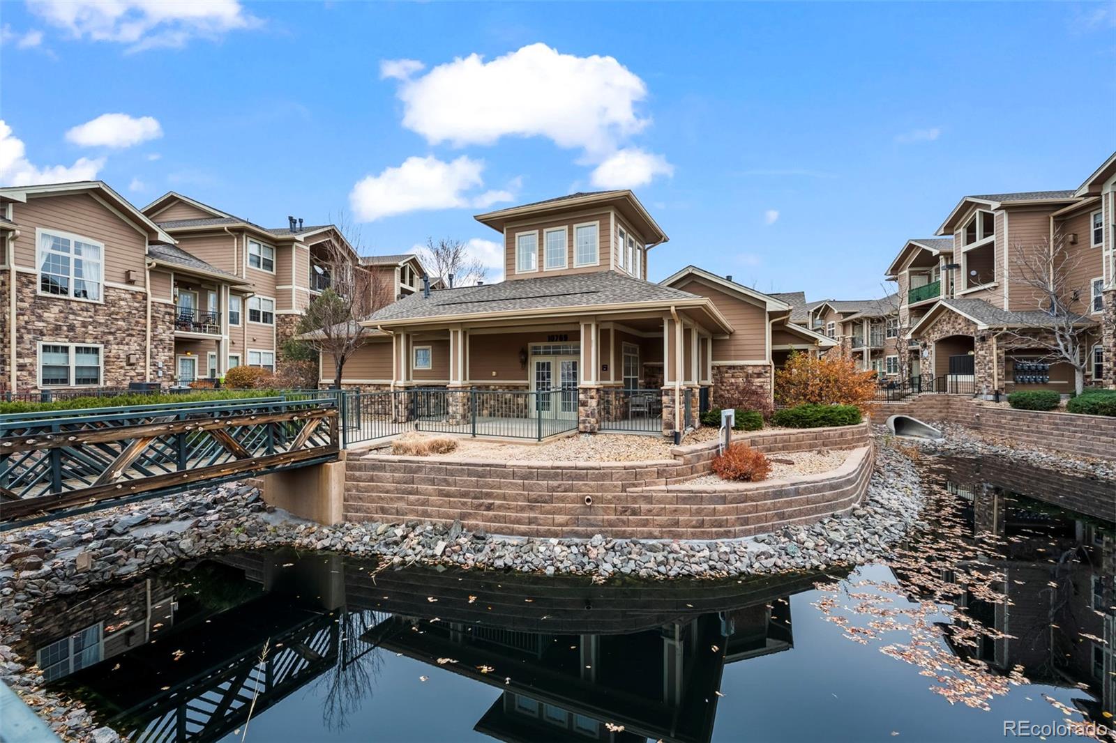 10787 Twenty Mile Road, Unit 301 Parker, CO 80134 - Photo 29 of 31 a view of a patio with table and chairs and potted plants