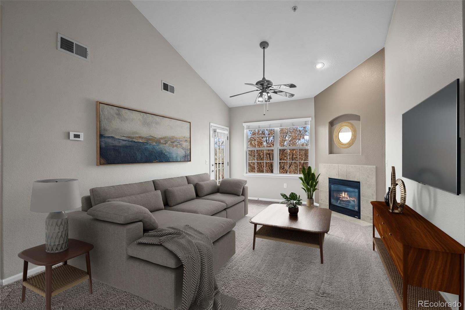 10787 Twenty Mile Road, Unit 301 Parker, CO 80134 - Photo 4 of 31 a living room with furniture and a flat screen tv