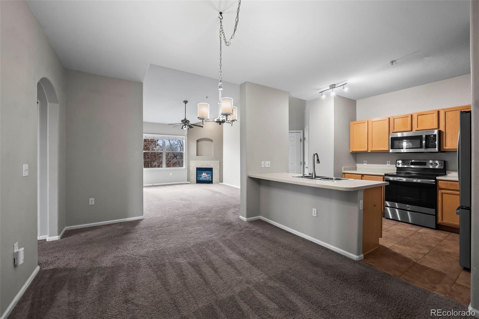10787 Twenty Mile Road, Unit 301 Parker, CO 80134 - Photo 7 of 31 a large kitchen with cabinets and stainless steel appliances