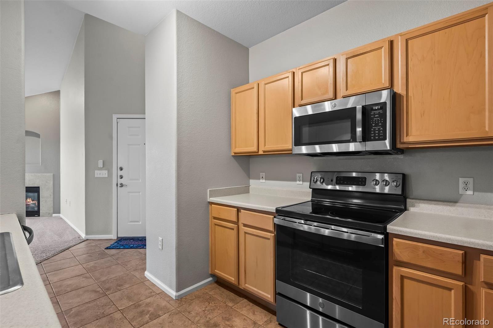 10787 Twenty Mile Road, Unit 301 Parker, CO 80134 - Photo 9 of 31 a kitchen with a stove and a microwave