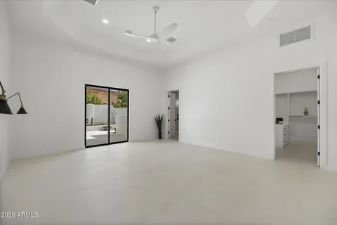 an empty room with windows and entrance