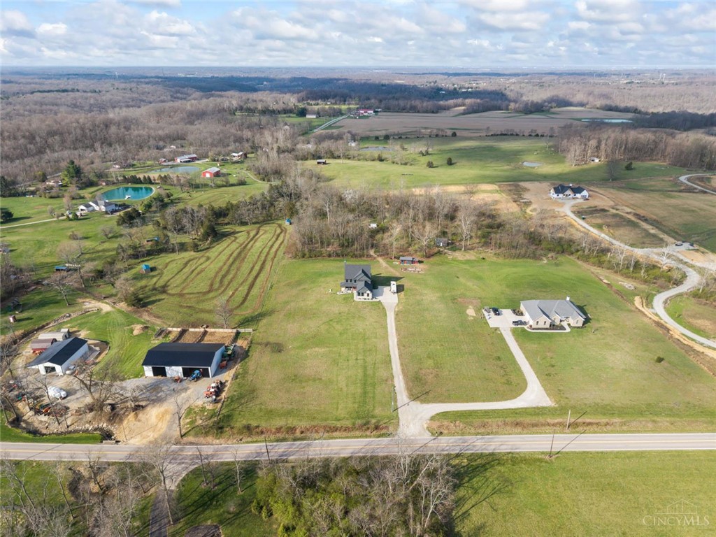2425 Middleboro Road Clarksville, OH 45113 - Photo 8 of 91 This expansive rural landscape features multiple homes and ample green space under a broad sky.