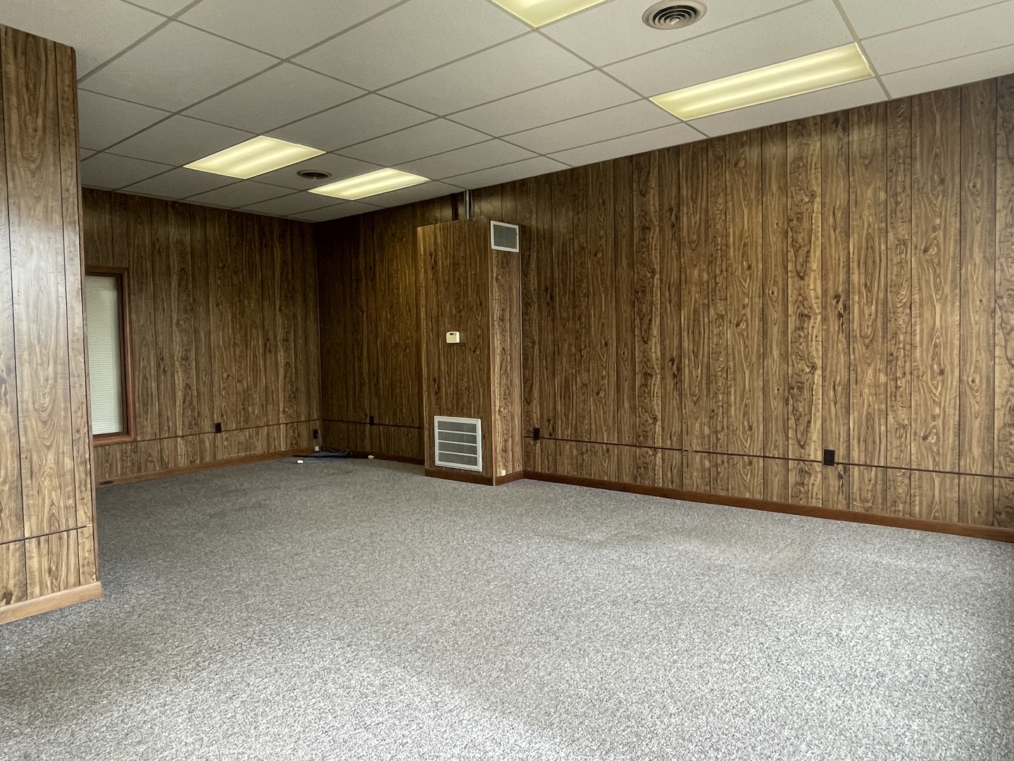 503 East 3rd Street Sterling, IL 61081 - Photo 7 of 10 an empty room with a wooden walls