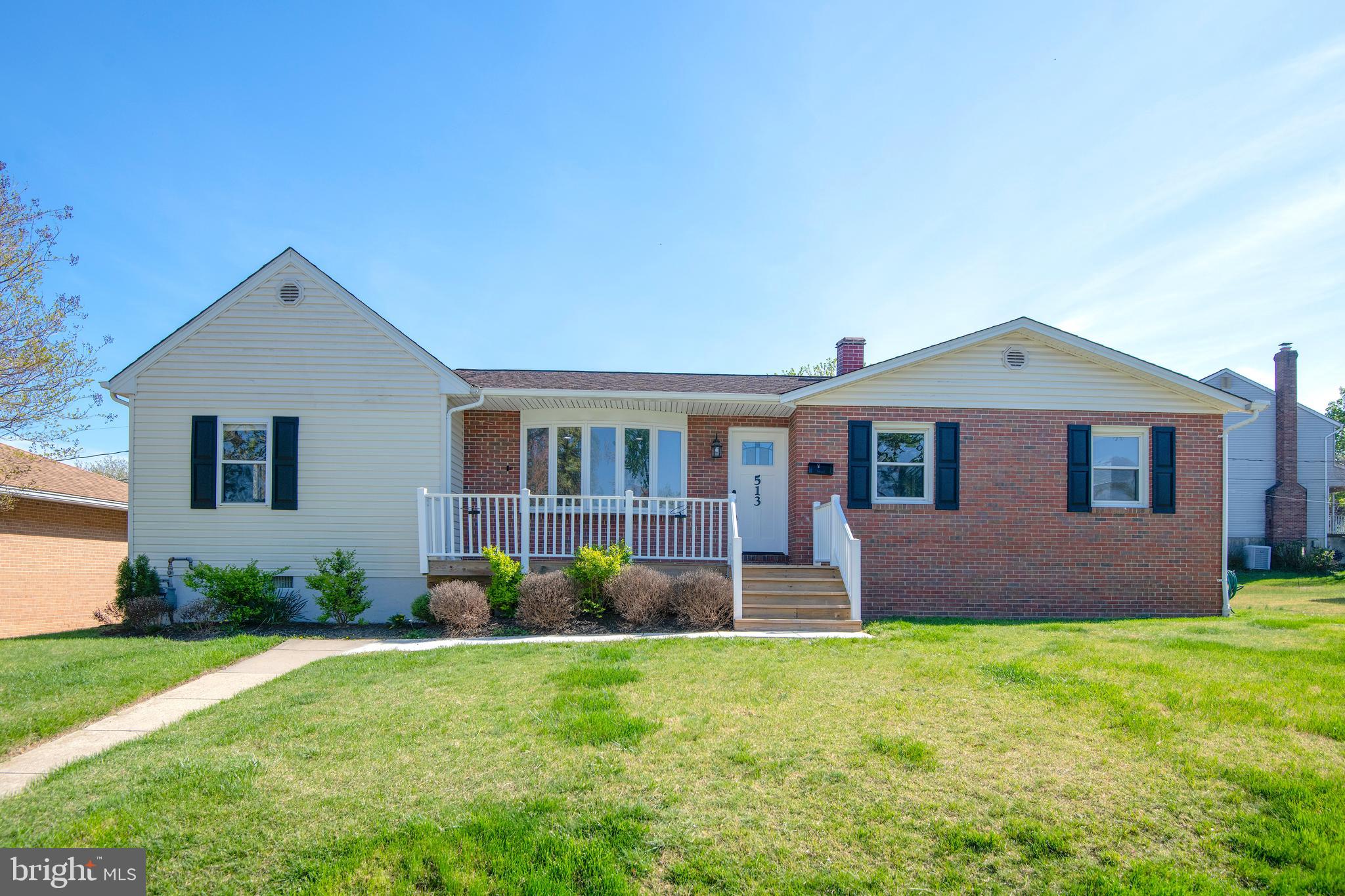 a front view of a house with a garden and plants