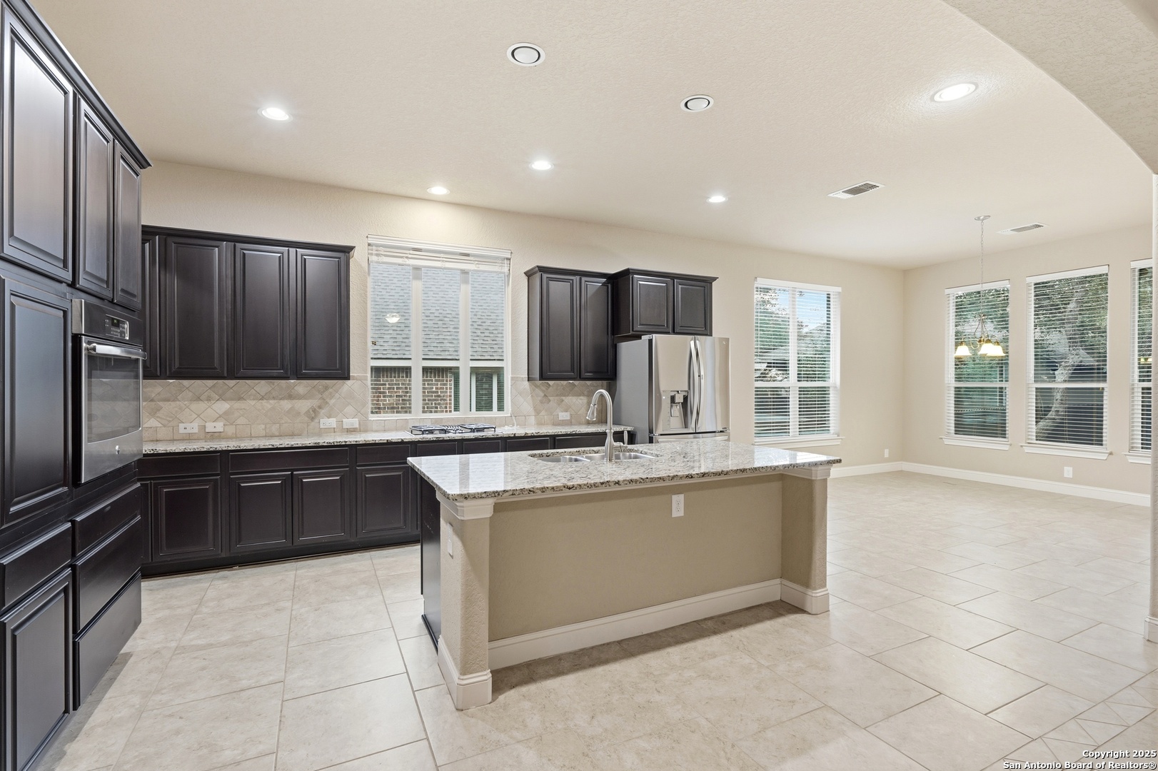 8234 Two Winds San Antonio, TX 78255 - Photo 13 of 37 a large kitchen with granite countertop a stove and a sink