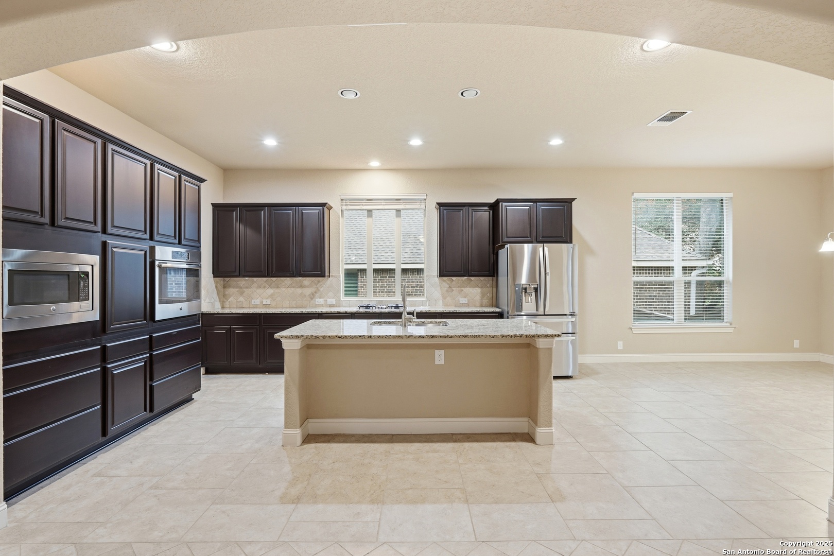 8234 Two Winds San Antonio, TX 78255 - Photo 14 of 37 a kitchen with stainless steel appliances granite countertop a stove a sink and a refrigerator