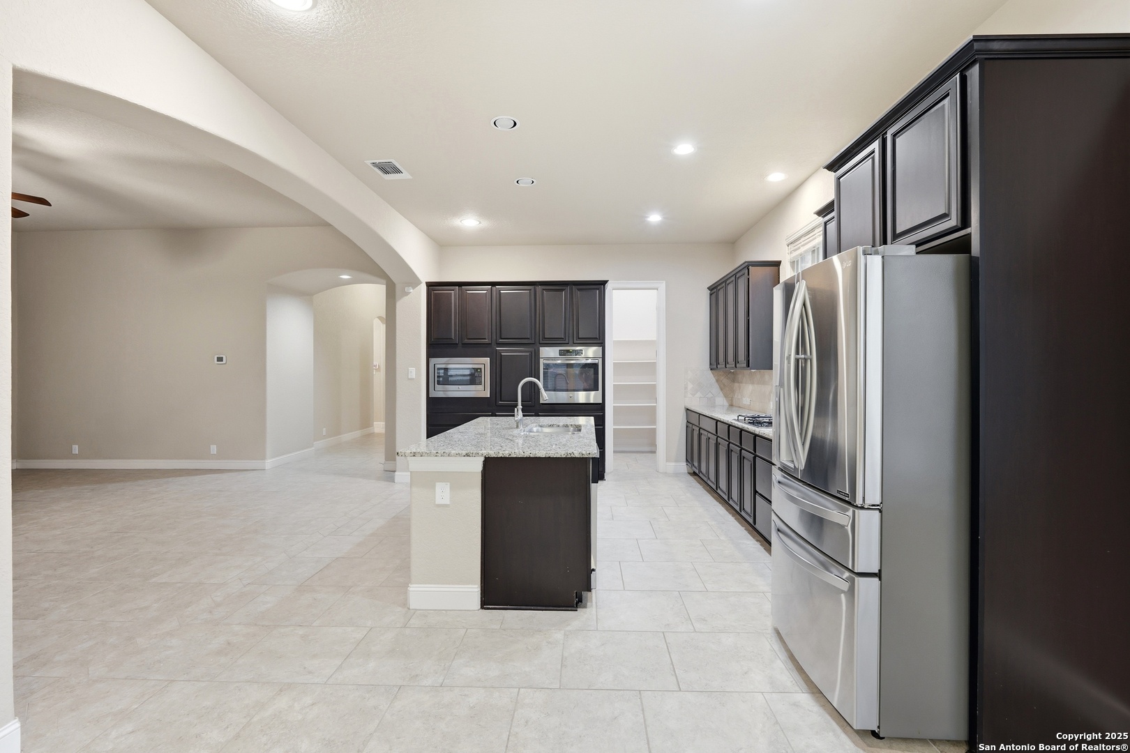 8234 Two Winds San Antonio, TX 78255 - Photo 16 of 37 a kitchen with stainless steel appliances granite countertop a refrigerator and a sink