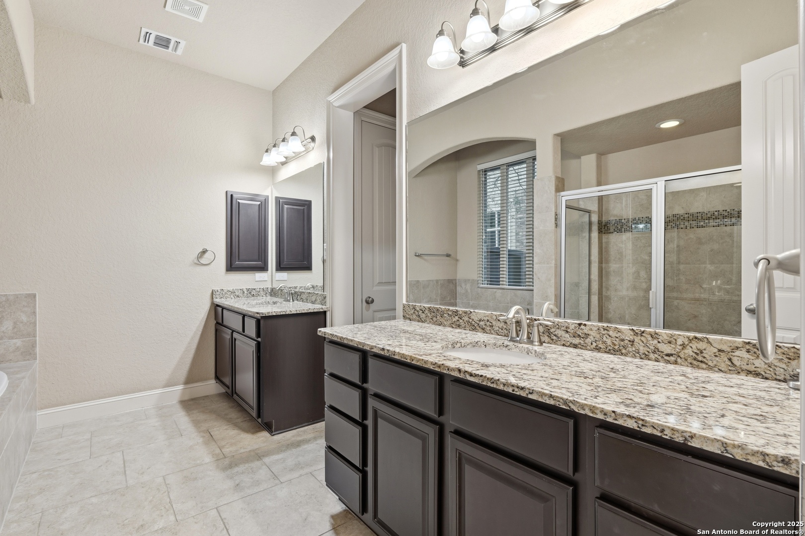 8234 Two Winds San Antonio, TX 78255 - Photo 20 of 37 a bathroom with a granite countertop sink and a mirror