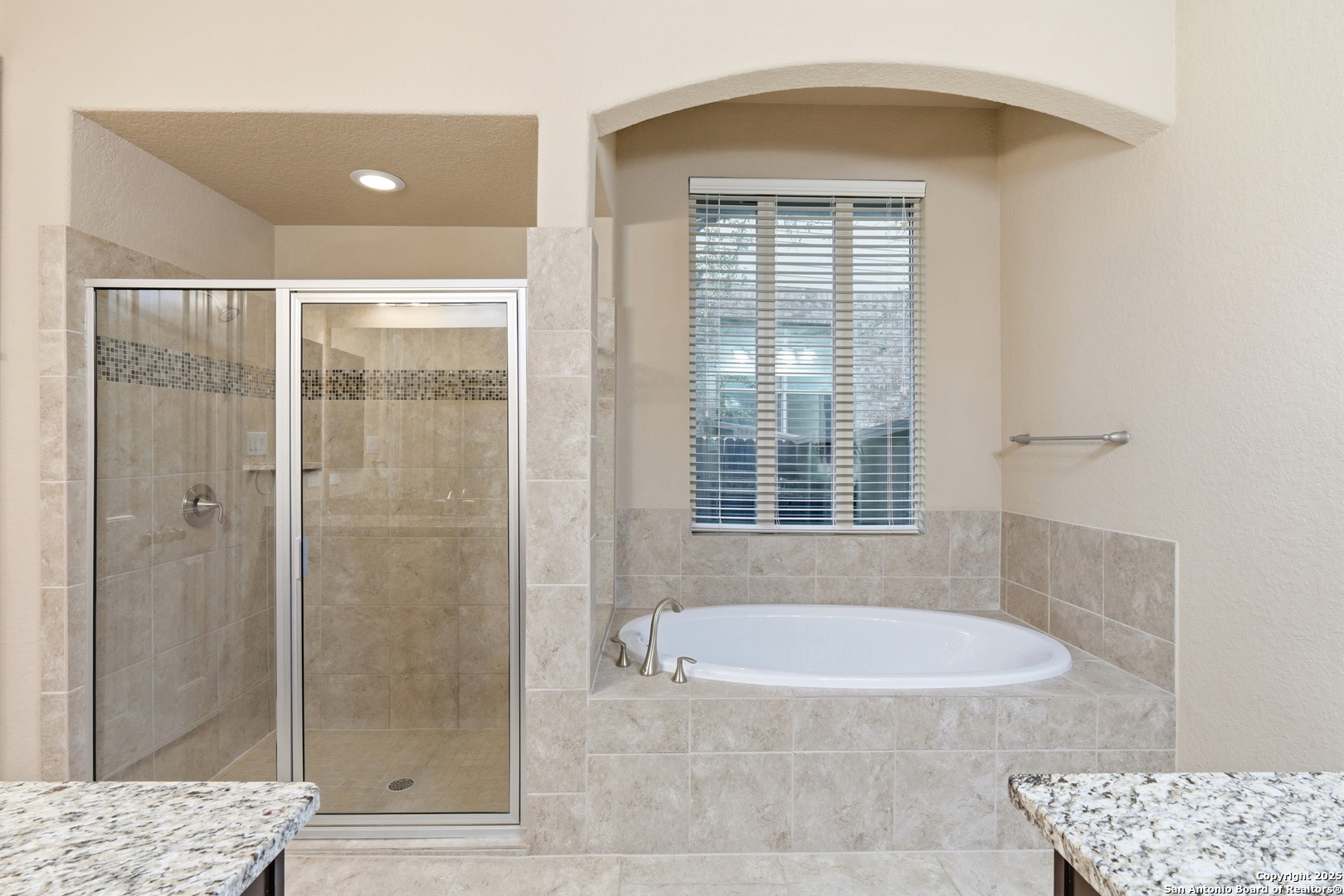 8234 Two Winds San Antonio, TX 78255 - Photo 21 of 37 a bathroom with a granite countertop bathtub shower and checkered floor