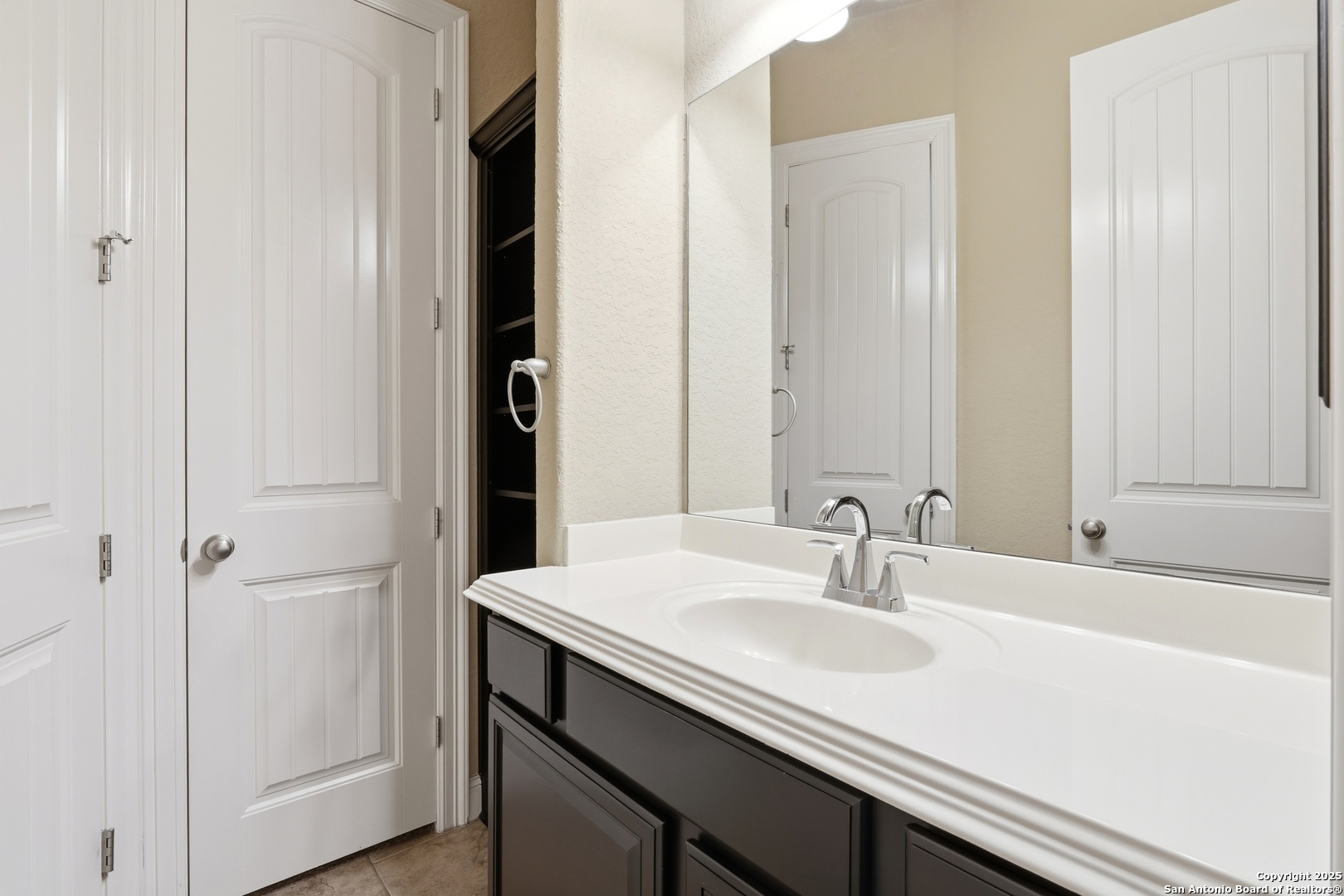 8234 Two Winds San Antonio, TX 78255 - Photo 23 of 37 a bathroom with a sink and a mirror