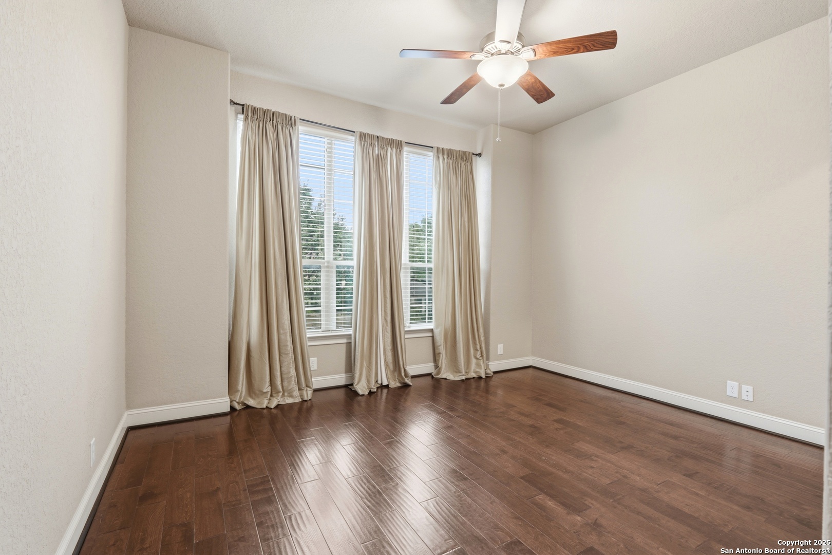 8234 Two Winds San Antonio, TX 78255 - Photo 7 of 37 an empty room with wooden floor fan and windows