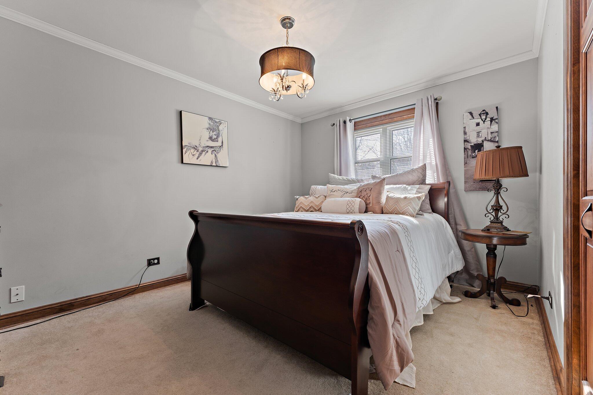 6881 West 86th Court Crown Point, IN 46307 - Photo 13 of 28 a bed room with a bed and a chair