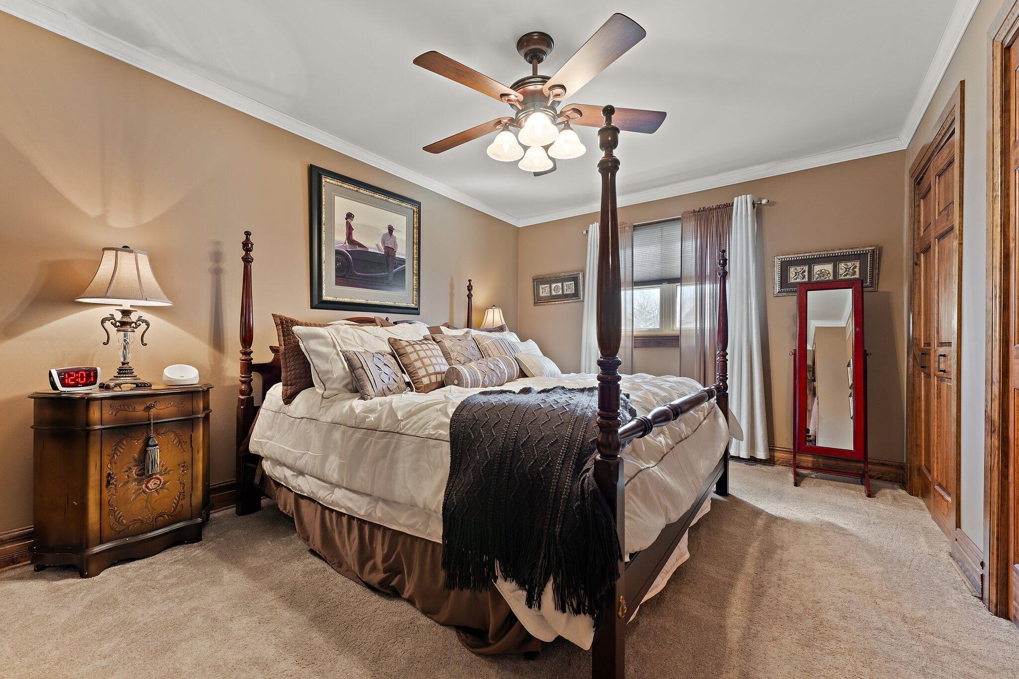 6881 West 86th Court Crown Point, IN 46307 - Photo 14 of 28 a bed room with a bed and a chandelier