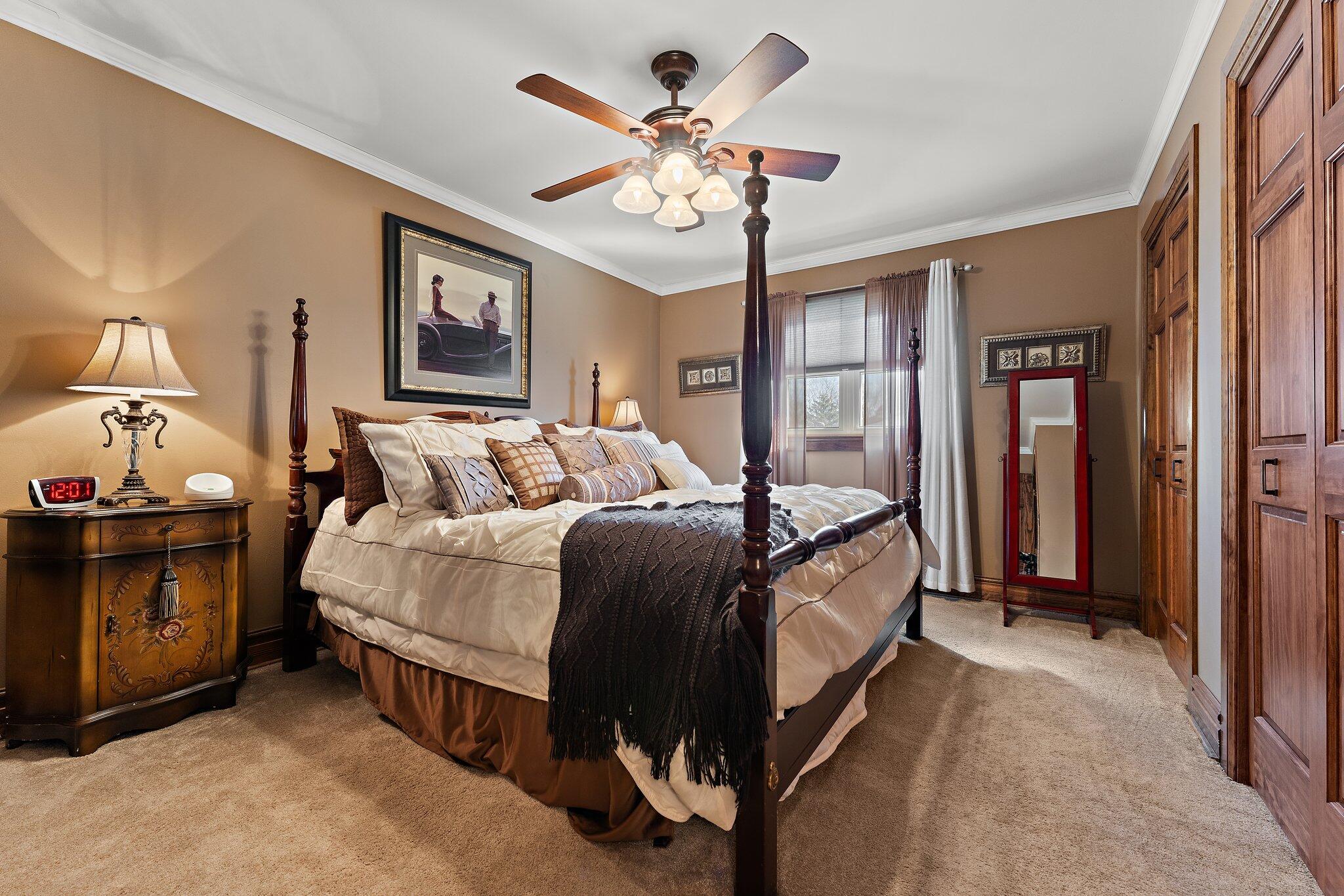 6881 West 86th Court Crown Point, IN 46307 - Photo 15 of 28 a bed room with a bed and a chandelier