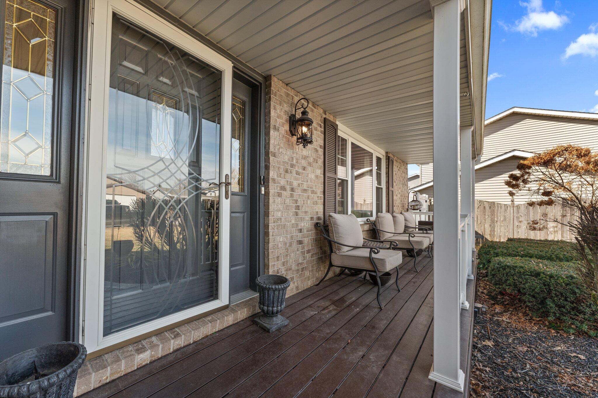 6881 West 86th Court Crown Point, IN 46307 - Photo 4 of 28 a view of a balcony with chairs and floor to ceiling window