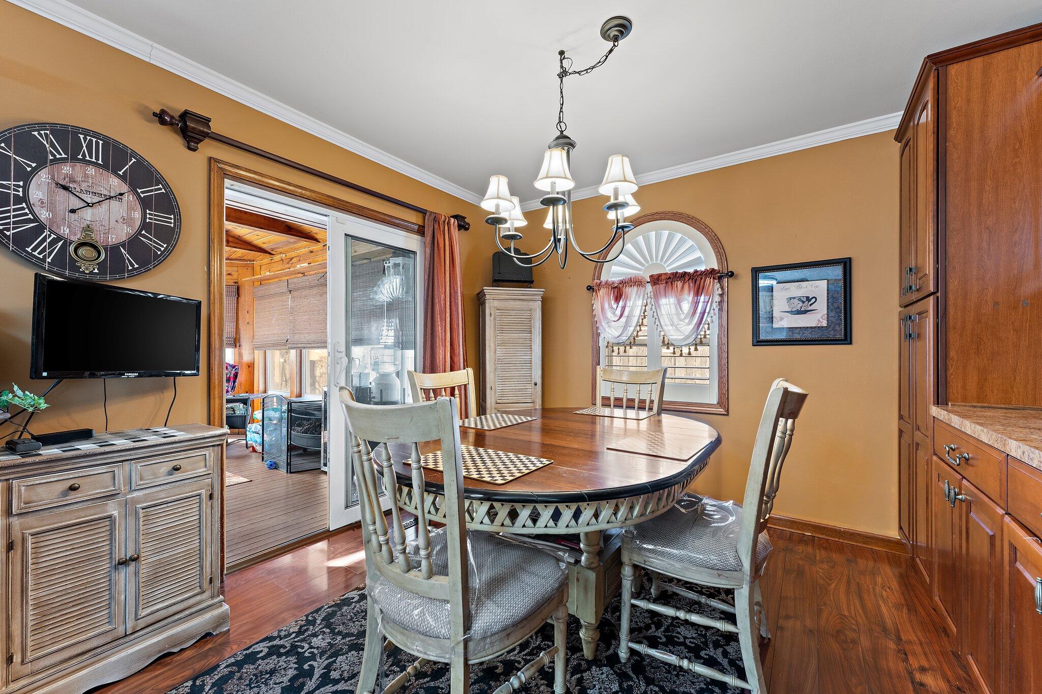 6881 West 86th Court Crown Point, IN 46307 - Photo 9 of 28 a view of a dining room with furniture wooden floor and chandelier