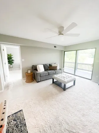 a living room with furniture and a lamp