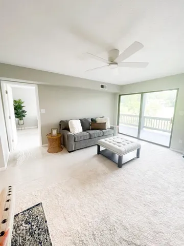 a living room with furniture and a lamp