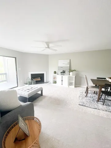 a living room with furniture and white appliances