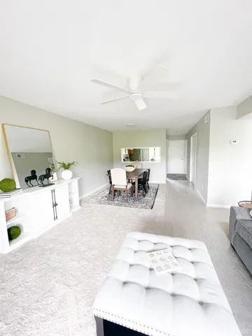 a bedroom with furniture and a large window