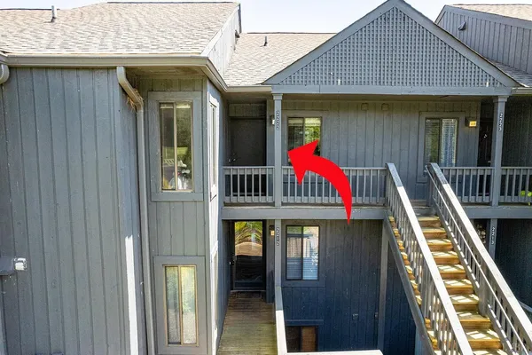 a view of an wooden house with large windows