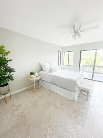 a spacious bedroom with a bed and a window