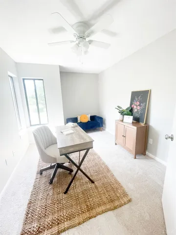 a work room with furniture and a rug