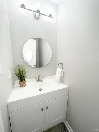 a white toilet sitting next to a white wall