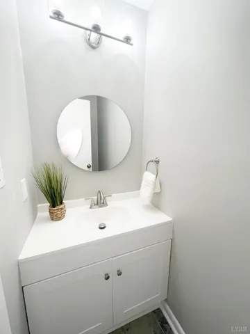 a white toilet sitting next to a white wall