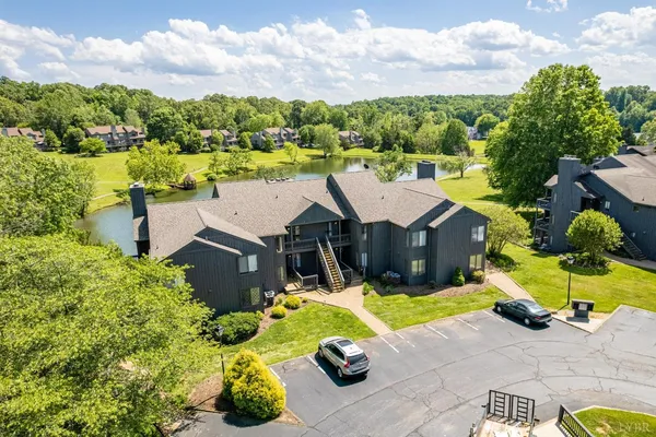 an aerial view of residential houses with outdoor space and lake view