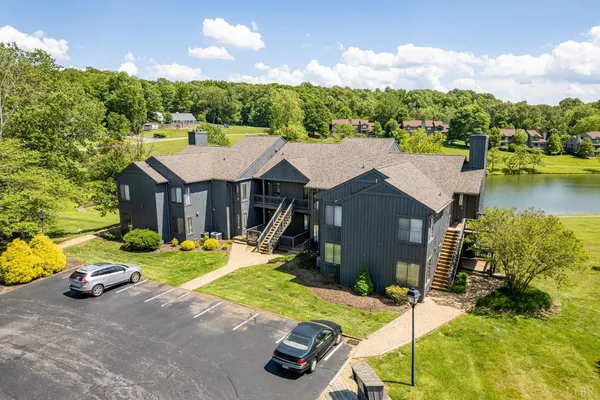 an aerial view of residential houses with outdoor space and ocean view