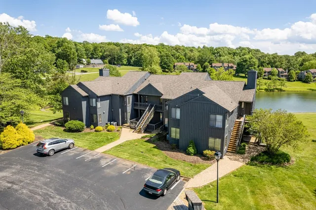 an aerial view of residential houses with outdoor space and ocean view