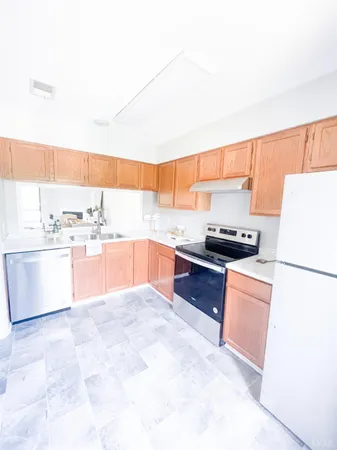 a kitchen with stainless steel appliances kitchen island granite countertop a sink counter top space and cabinets