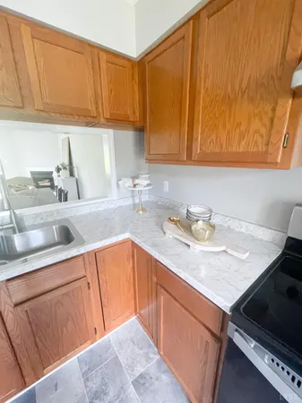 a kitchen with a sink cabinets and a stove top oven