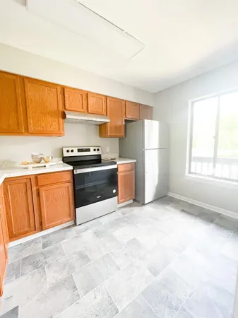 a kitchen with granite countertop a sink and a stove