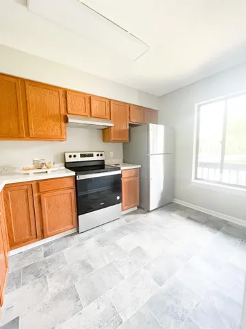 a kitchen with granite countertop a sink and a stove