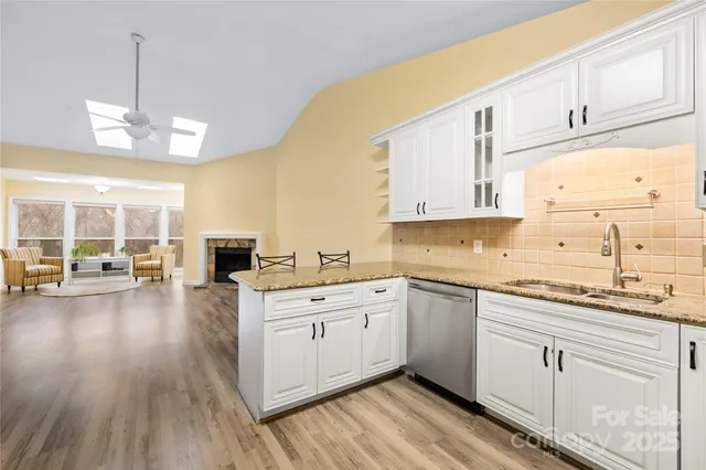 a kitchen with a sink window and cabinets