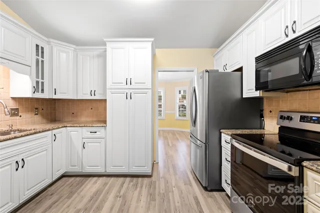 a kitchen with a refrigerator stove and microwave