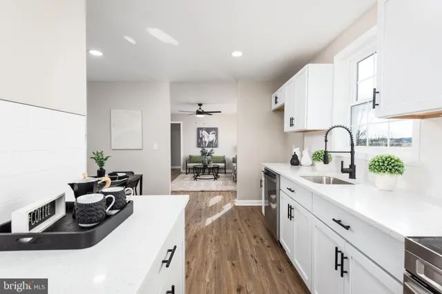 a kitchen with a sink stove and cabinets