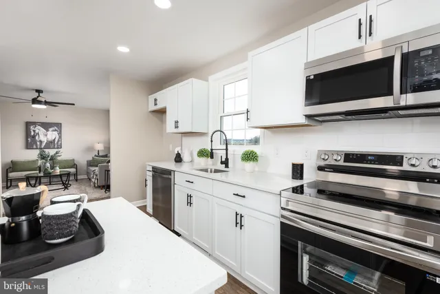 a kitchen with stainless steel appliances a stove microwave and cabinets