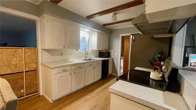 a kitchen with refrigerator a sink and wooden cabinets