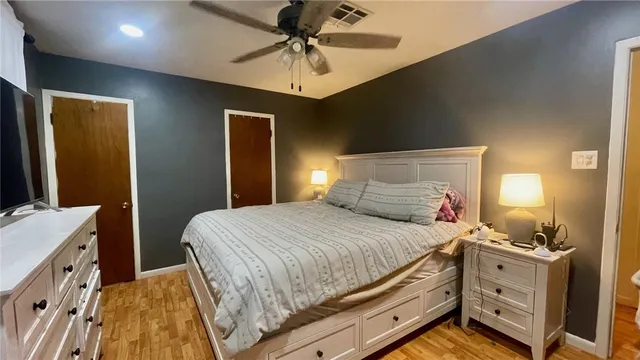 a view of a room with gym equipment and wooden floor