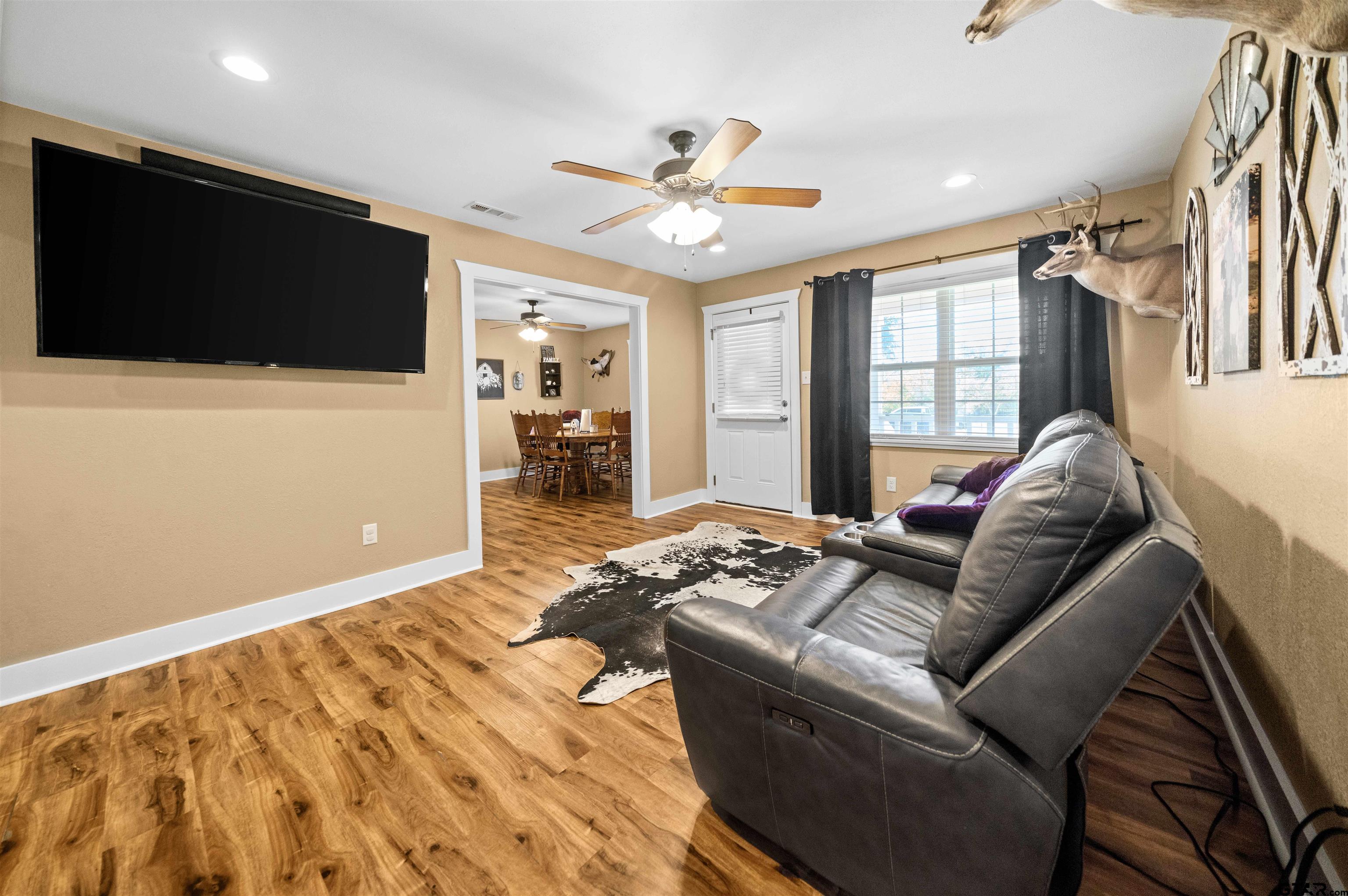 8781 Farm To Market 59 Athens, TX 75751 - Photo 11 of 37 a living room with furniture and a flat screen tv
