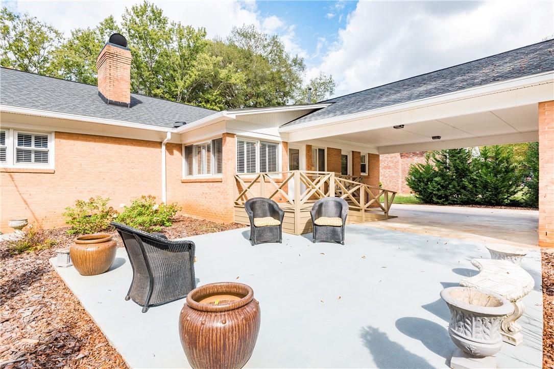 1001 Lansdowne Road Charlotte, NC 28270 - Photo 11 of 17 a view of a patio with couches chairs and potted plants