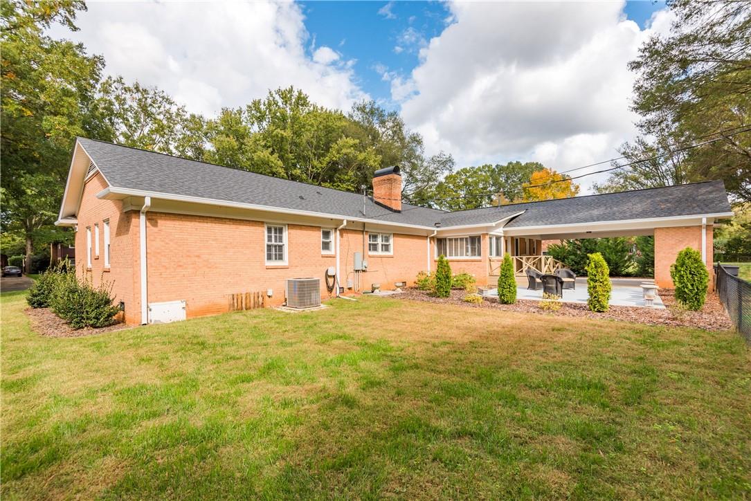 1001 Lansdowne Road Charlotte, NC 28270 - Photo 12 of 17 a view of a house with a big yard and large tree