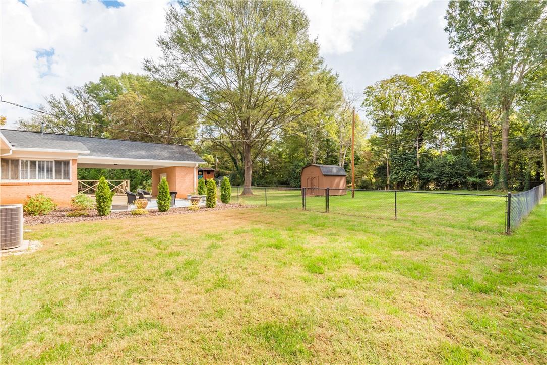 1001 Lansdowne Road Charlotte, NC 28270 - Photo 13 of 17 a view of house with a backyard