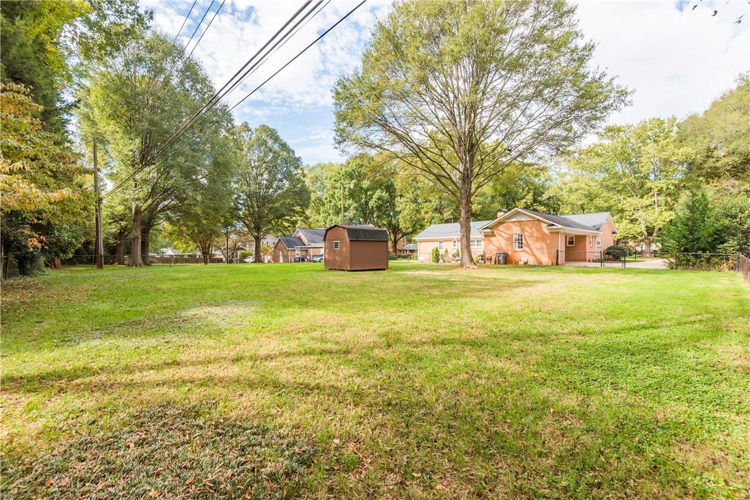 1001 Lansdowne Road Charlotte, NC 28270 - Photo 15 of 17 a house view with swimming pool in front of it