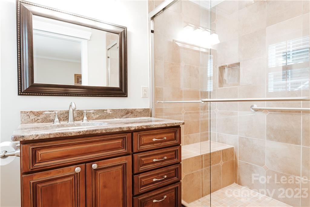 1001 Lansdowne Road Charlotte, NC 28270 - Photo 8 of 17 a bathroom with a granite countertop sink a mirror and a