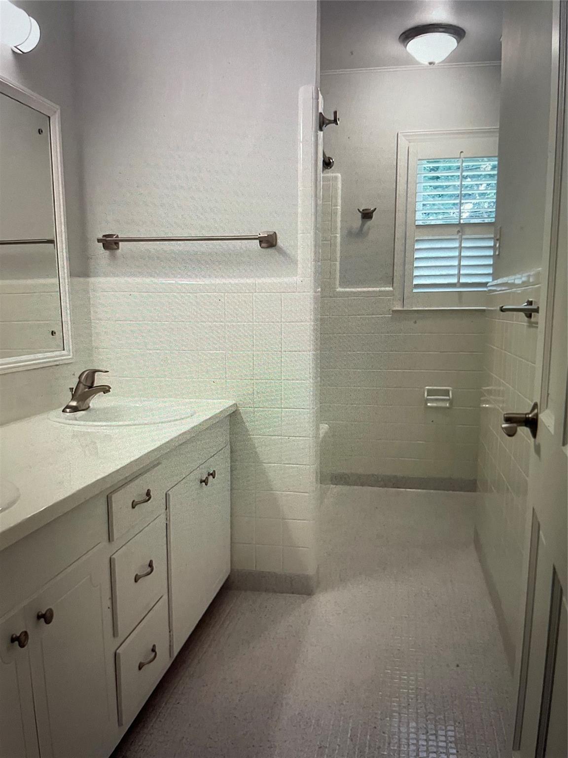 1001 Lansdowne Road Charlotte, NC 28270 - Photo 9 of 17 a spacious bathroom with a double vanity sink a large mirror and a bathtub