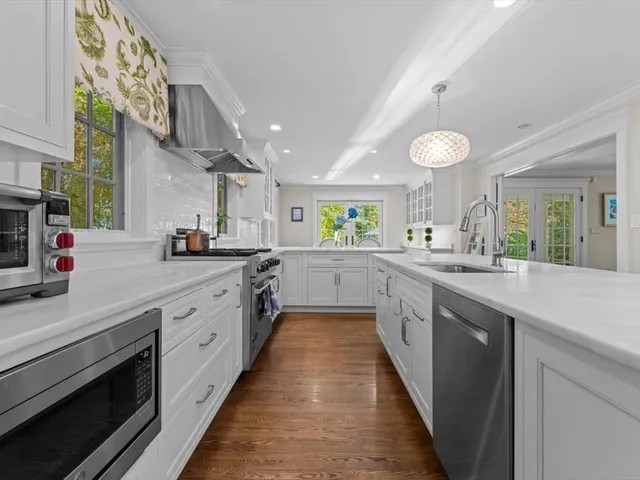 a kitchen with stainless steel appliances granite countertop lots of counter top space and a sink